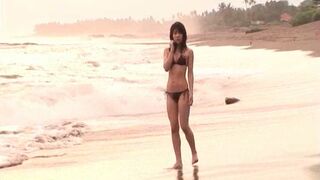 Japanese Beauty Seduces on Sunlit Beach in Sexy Bikini Adventure