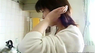 Japanese beauty with hairy pussy pleasures herself using a carrot