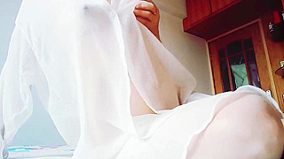 Seductive Woman in White Dress Pleasures Herself in Luxurious Bedroom