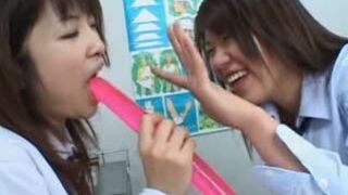 Two Cute Asian Lesbians Share Massive Double Headed Dildo
